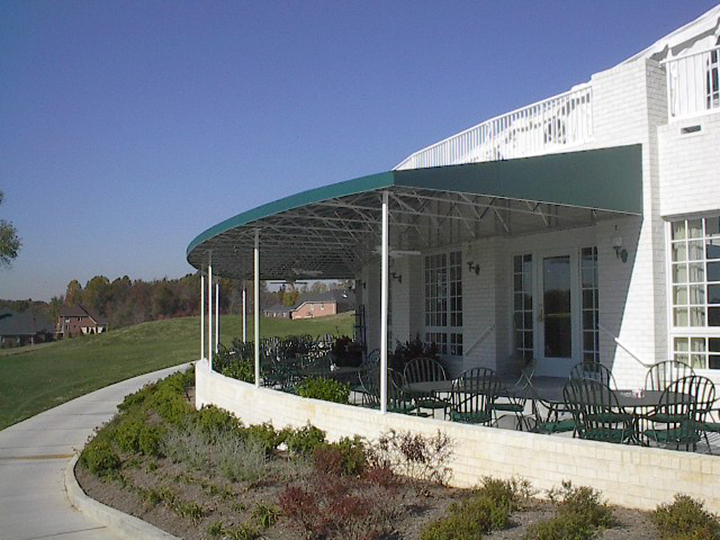 canopy stretched over large dining area that is a bluish green